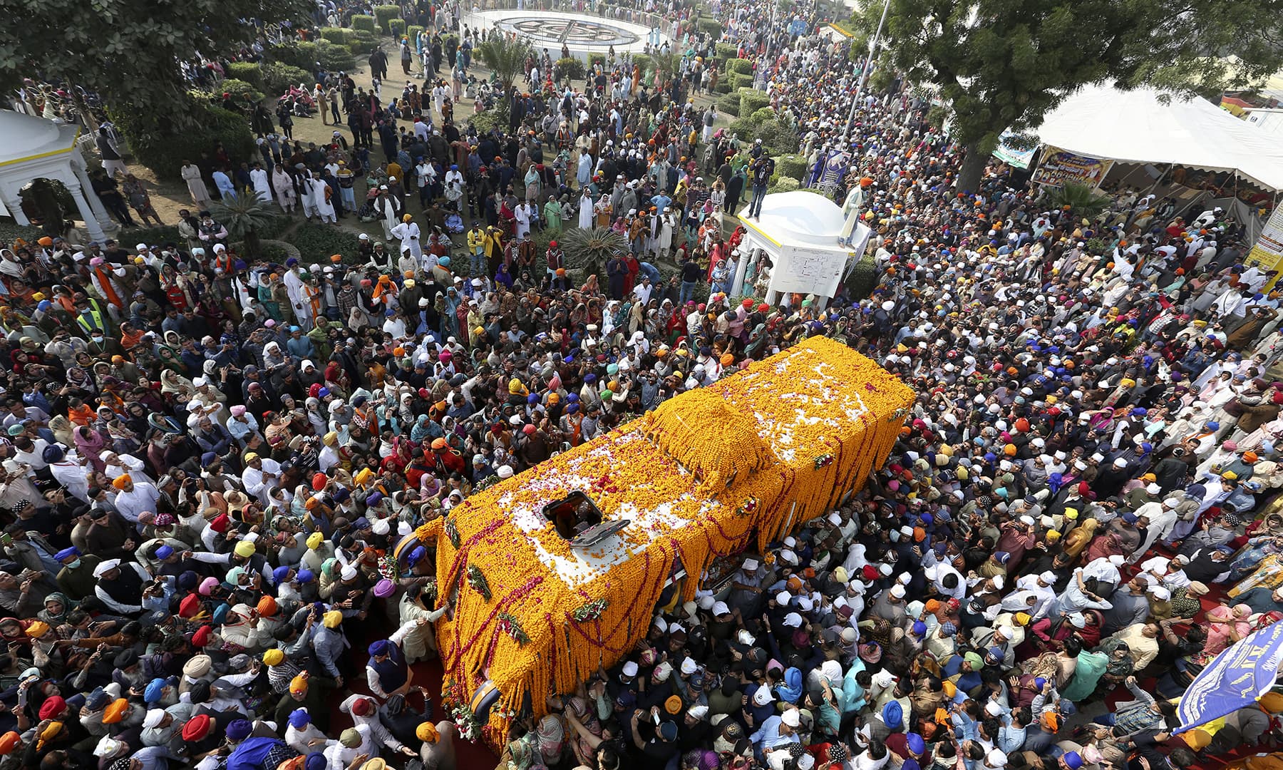 Sikh pilgrims attend a ceremony to celebrate the birth anniversary of Baba Guru Nanak Dev in Nankana Sahib, Friday. — AP