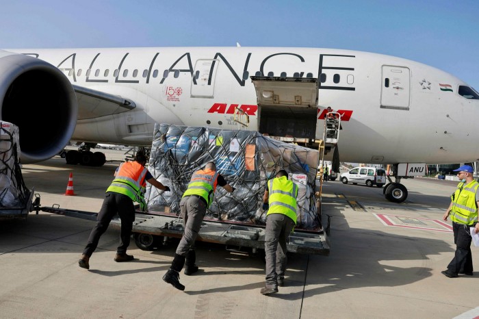 Workers at Israel’s Ben Gurion Airport near Tel Aviv load medical aid on to an Air India aeroplane