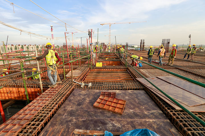 the workers are working on the third terminal building of hazrat shahjalal international airport.