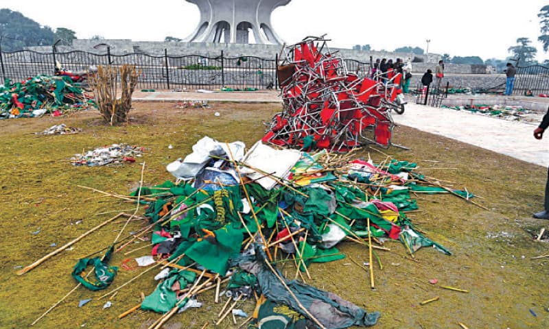 Piles of broken chairs, fence, party flags and flexes litter the Greater Iqbal Park on Monday, a day after the Pakistan Democratic Movement rally. — White Star