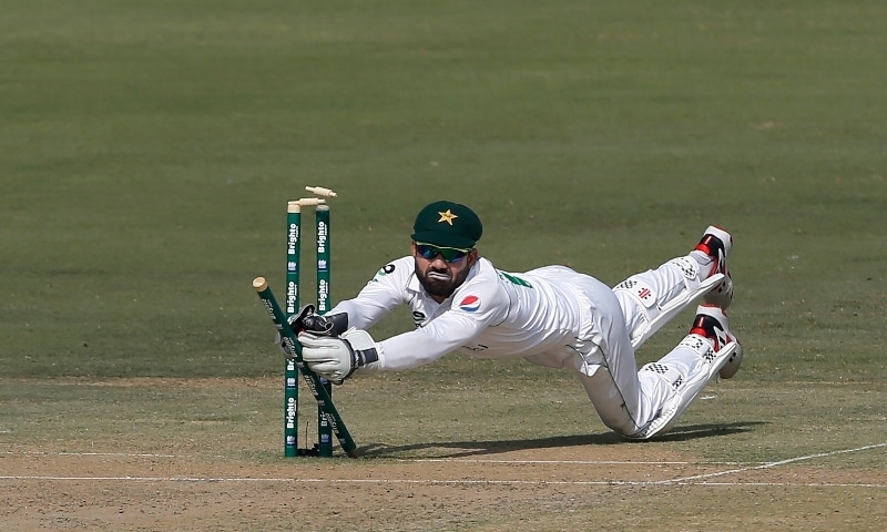 Pakistan's wicketkeeper Mohammad Rizwan shatters bails to run-out South Africa's batsman Rassie van der Dussen during the first day of the first cricket test match between Pakistan and South Africa at the National stadium on Jan 26. — AP