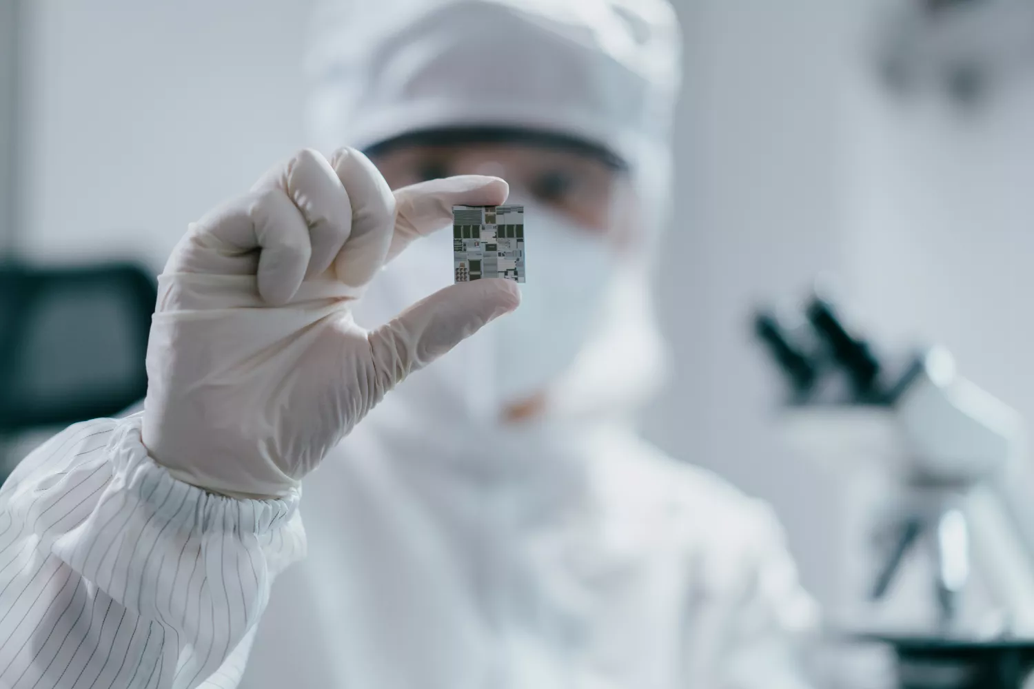 A scientist inspecting a computer chip. 