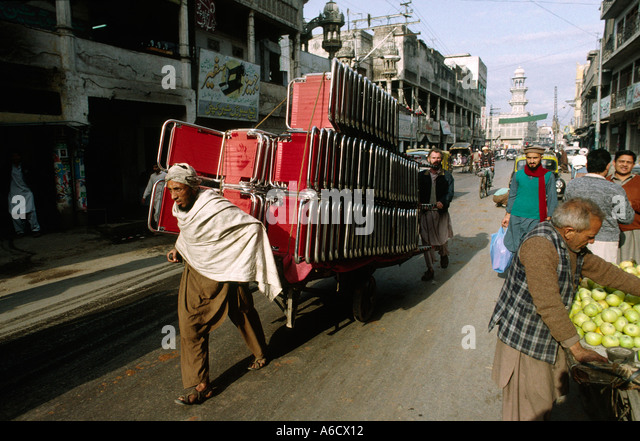pakistan-rawalpindi-rajah-bazaar-men-pulling-cart-loaded-with-chairs-a6cx12.jpg