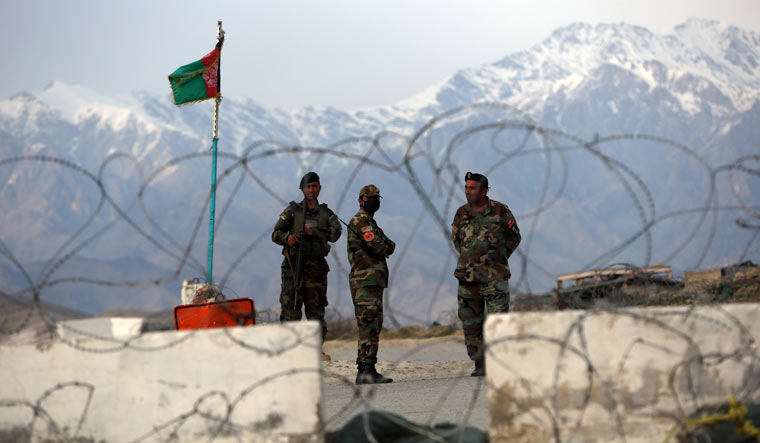 [File] Afghan National Army soldiers stand guard at a checkpoint near the Bagram base in northern Kabul | AP