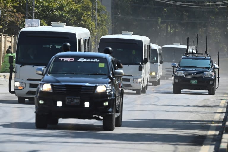 Security personnel escort a convoy carrying Australian and Pakistani cricketers as they arrive at the Rawalpindi Cricket Stadium (AFP/Aamir QURESHI)