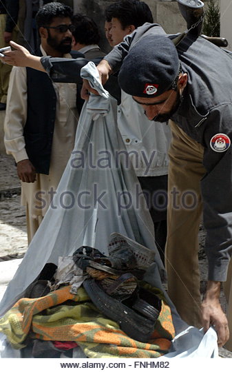 epa02119396-a-police-officer-collect-sandals-at-the-scene-of-a-suicide-fnhm82.jpg