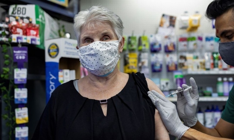 A woman receives the Pfizer-BioNTech coronavirus disease vaccine as a booster dose at Skippack Pharmacy in Schwenksville, Pennsylvania, US, August 14, 2021. — Reuters