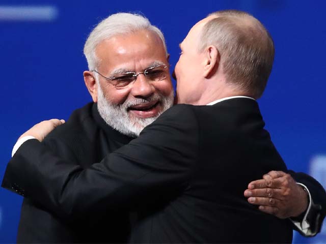 vladimir putin embraces narendra modi during a session at spief in 2017 photo afp