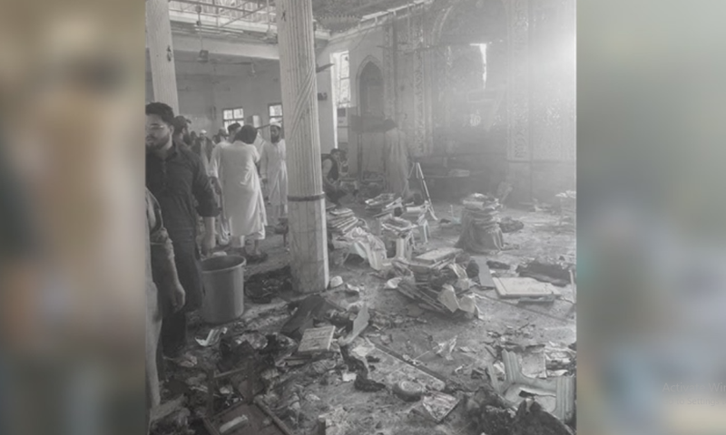 People are seen at the site of the blast in Peshawar's Dir Colony. — DawnNewsTV's Dir Colony. — DawnNewsTV
