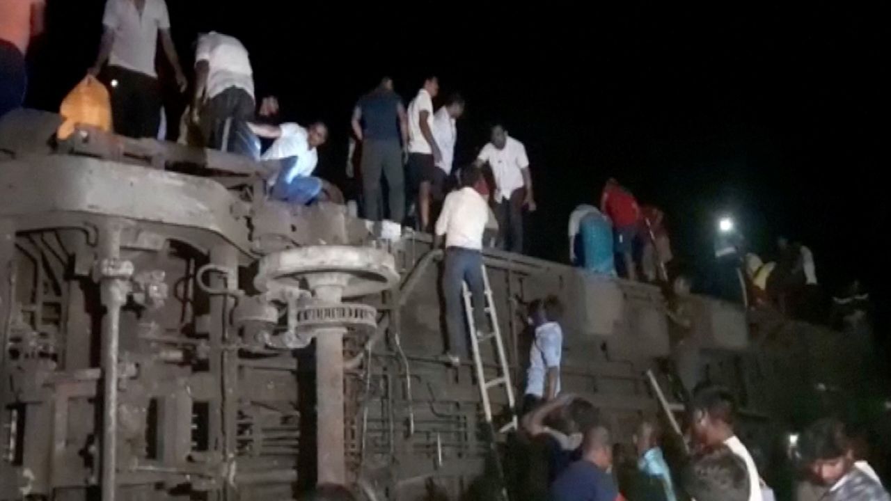 People try to escape from toppled compartments, following the deadly collision of two trains, in Balasore, India June 2, 2023, in this screen grab obtained from a video. 