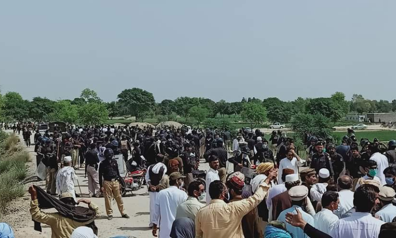 Protesters from the Janikhel area of Bannu are seen during their march while policemen are also present. — Photo by Sirajuddin