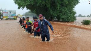 National Disaster Response Force personnel rescue people stranded in floodwaters in Kolhapur, in the western Indian state of Maharashtra, on Friday.