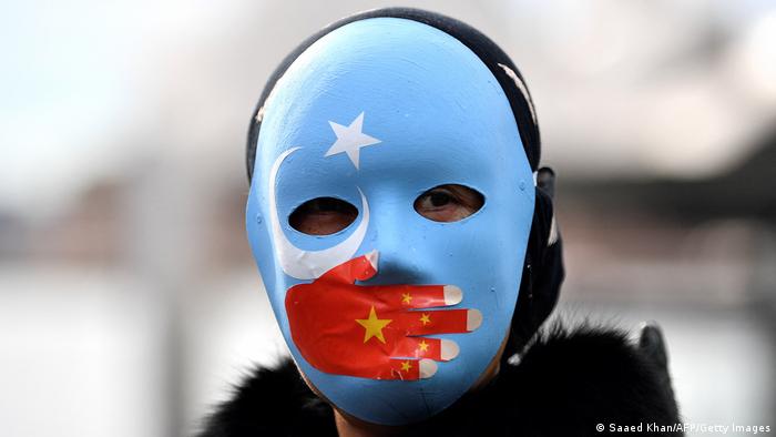 In Sydney, a mask depicting the silencing of East Turkestan by China.