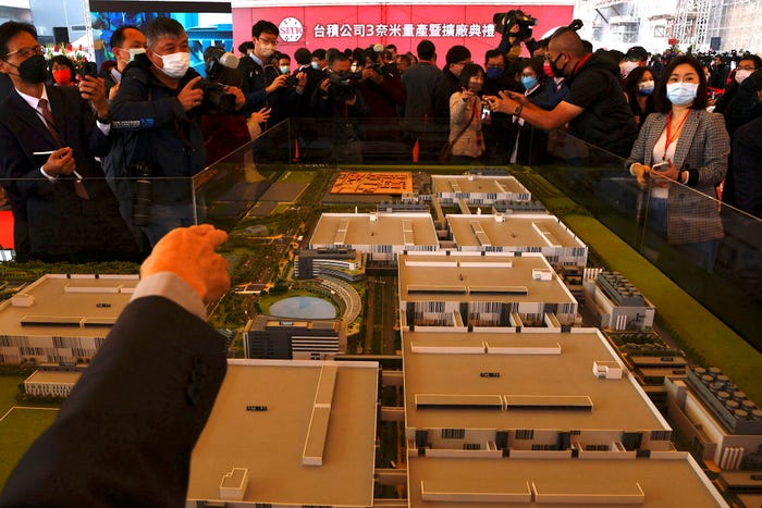 People view a model of the TSMC fab map at a ceremony to start mass production of its most advanced 3-nanometer chips in the southern city of Tainan, Taiwan, December 29, 2022.