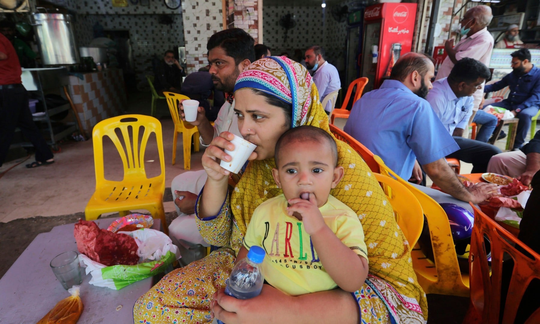 People eat at a restaurant following an ease in restrictions that had been imposed to help control the coronavirus in Karachi on August 10. — AP