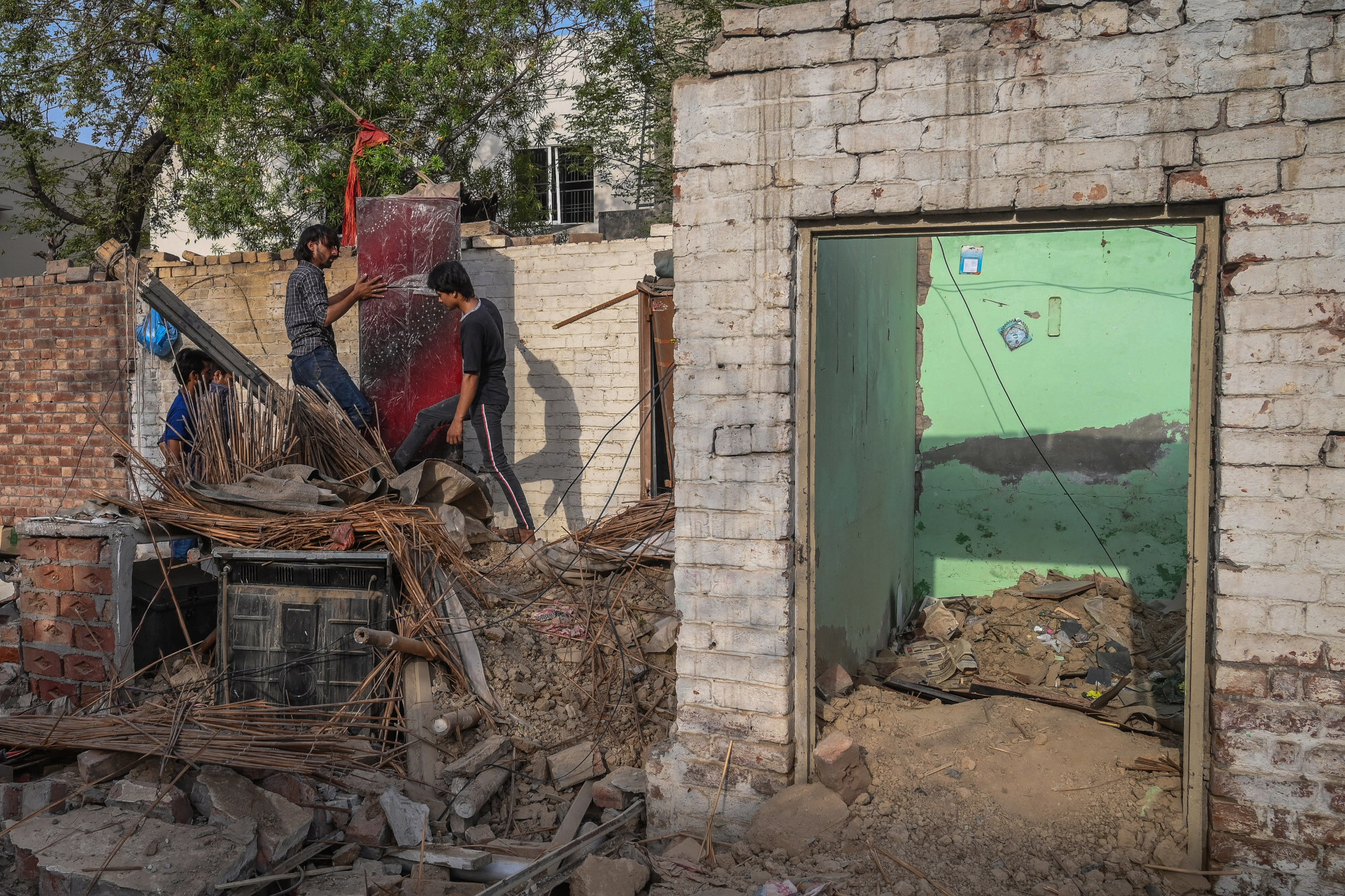 Locals scout for their belongings at the site of the June 23 explosion in Lahore. Photo: AFP