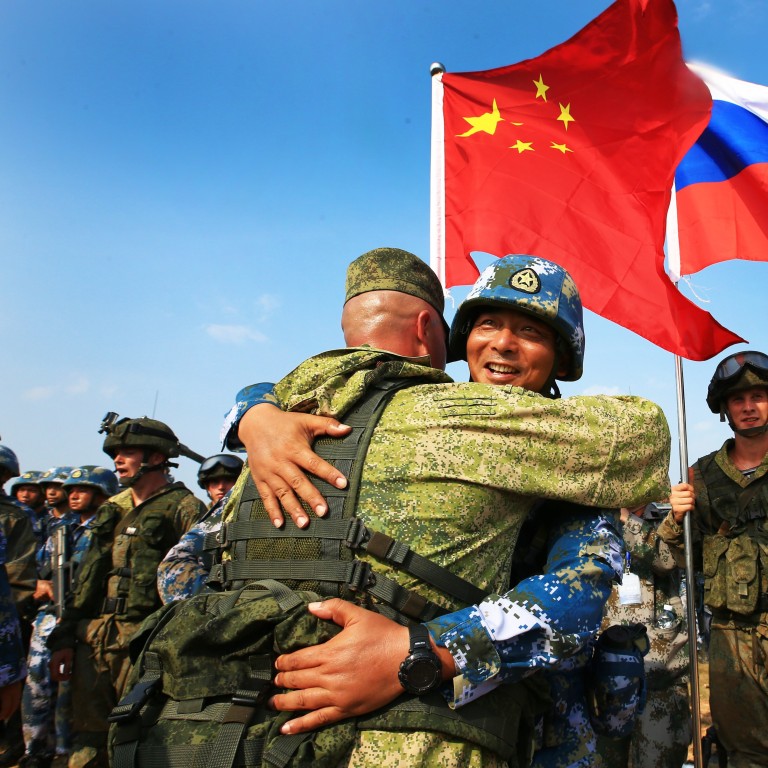 Chinese and Russian marines hug during a joint naval drill in China's Guangdong province in 2016. The two nations say their troops will stage an exercise together in Ningxia in August. Photo: Xinhua