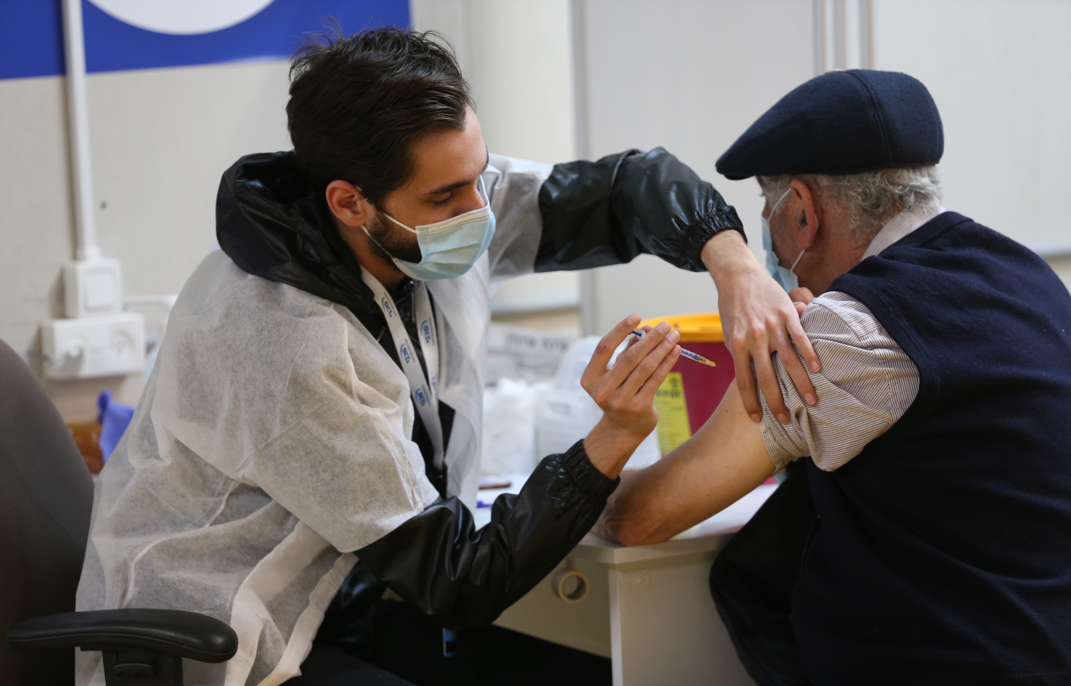 A man receives a dose of Covid-19 vaccine in central Israeli city of Givatayim, January 19