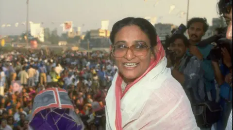 Getty Images Awami League ldr. Sheik Hasina Wazed on stump, holding party campaign item, during crowded election campaign rally, in a picture dated from 1991.