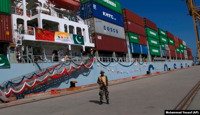 A Pakistani Navy soldier stands guard while a loaded Chinese ship prepares to depart from Gwadar Port. (file photo)