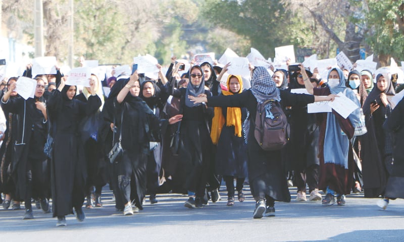Herat: Afghan girls chant “Education is our right, genocide is a crime” during a  march from the University of Herat to the provincial governor’s office on Sunday, two days after a suicide bomb attack at  a learning centre in Kabul.—AFP