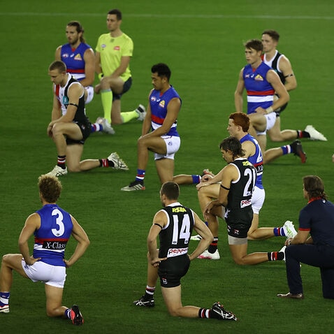 Players kneel during the round 3 AFL match between the St Kilda Saints and the Western Bulldogs on June 2020 in Melbourne.