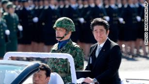 Shinzo Abe inspects Japan&apos;s Self-Defense Forces at Asaka Base, north of Tokyo, in 2013. 