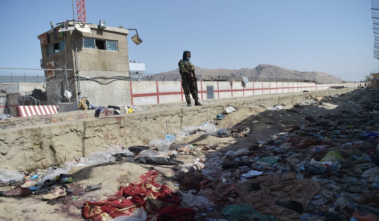 A Taliban fighter stands guard at the site of the August 26 suicide bombing at Kabul airport that killed scores of people, including 13 US troops. Photo: AFP