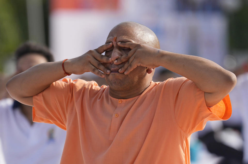 Chief Minister of Uttar Pradesh Yogi Adityanath performs yoga along with others to mark the International Day of Yoga in Lucknow, India, on June 21, 2022.<span class=copyright>Rajesh Kumar Singh/AP</span>
