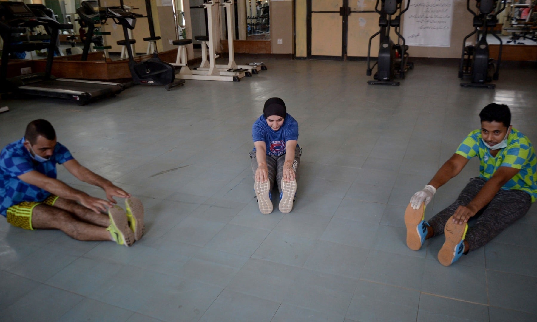 Athletes exercise at a gym following an ease in restrictions that had been imposed to help control the coronavirus in Peshawar on August 10. — AP