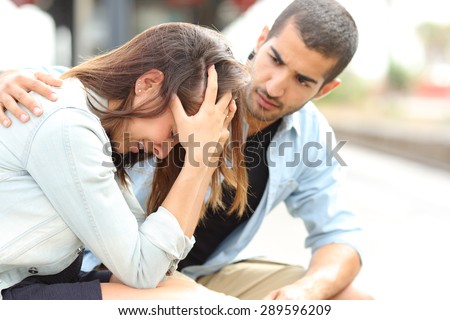 stock-photo-side-view-of-a-muslim-man-comforting-a-sad-caucasian-girl-mourning-in-a-train-station-289596209.jpg