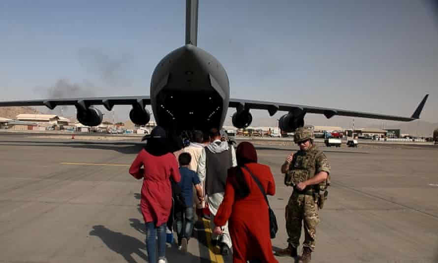 Afghans board an RAF flight to the UK at Kabul airport