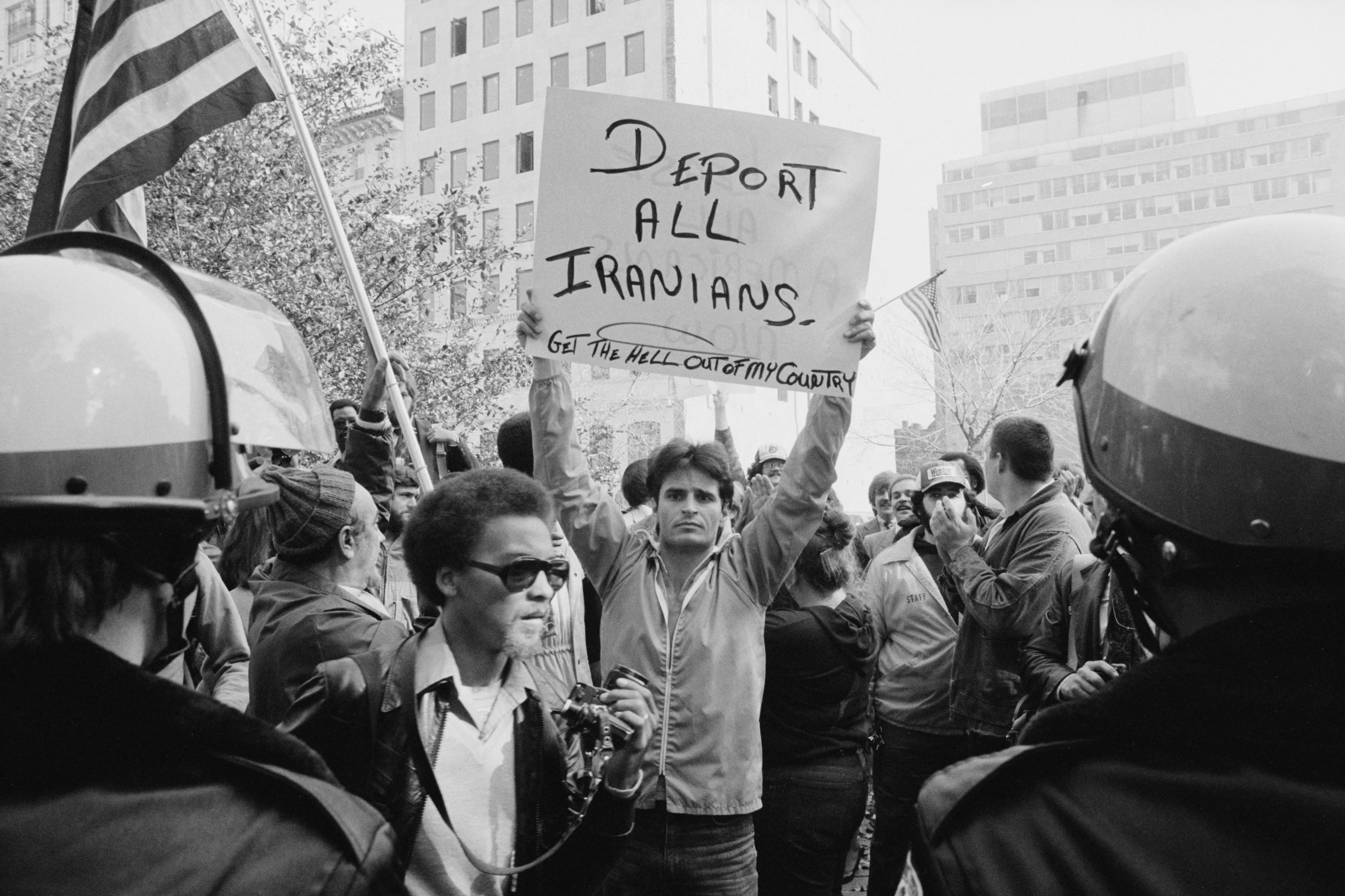 Man_holding_sign_during_Iranian_hostage_crisis_protest,_1979.jpg