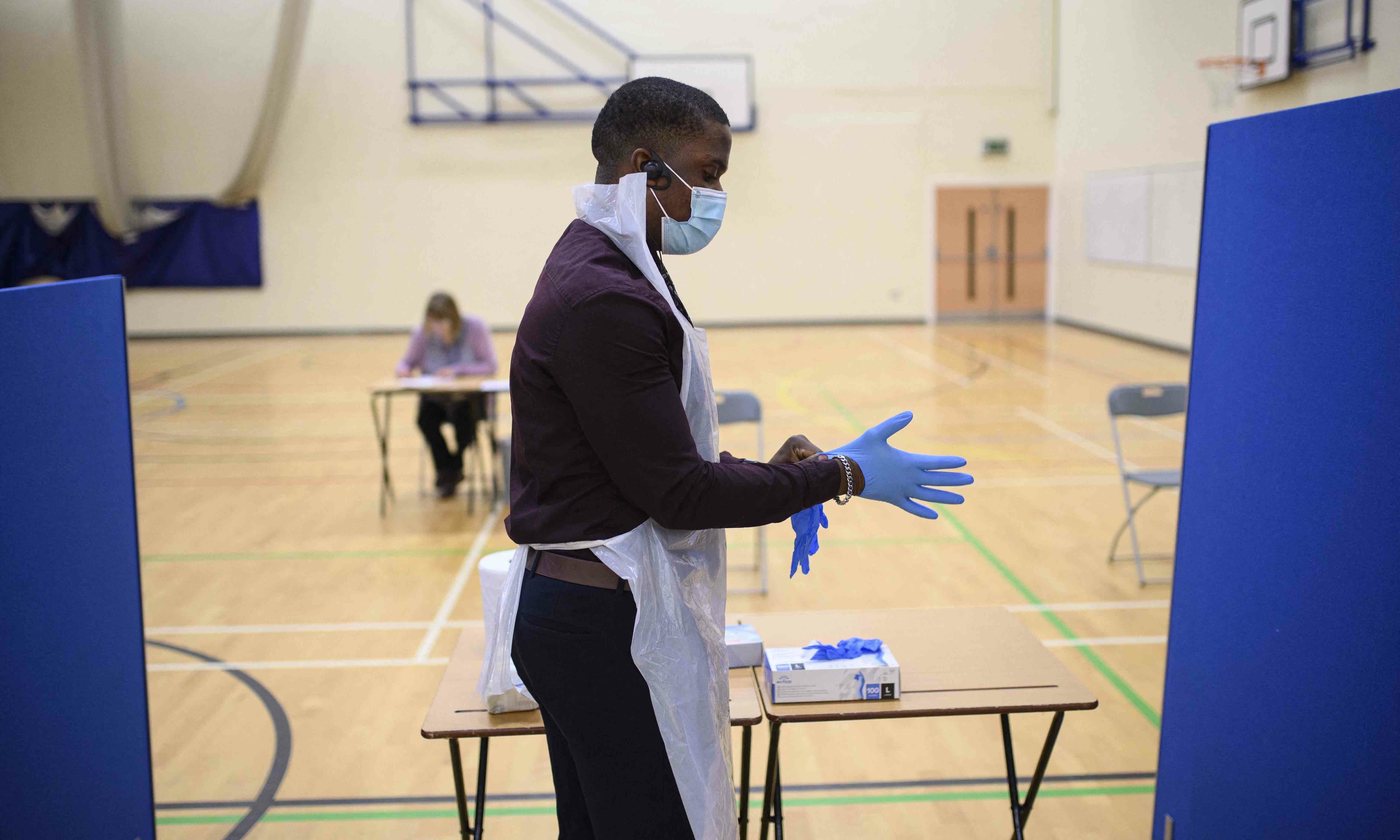 Staff at Park Lane Academy prepare to process Covid lateral flow tests as they undertake a programme to test every pupil on the first day of term, in Halifax, northwest England on January 4. — AFP