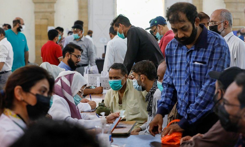 People wait to get vaccinated against Covid-19 at a centre in Karachi. — Reuters/File