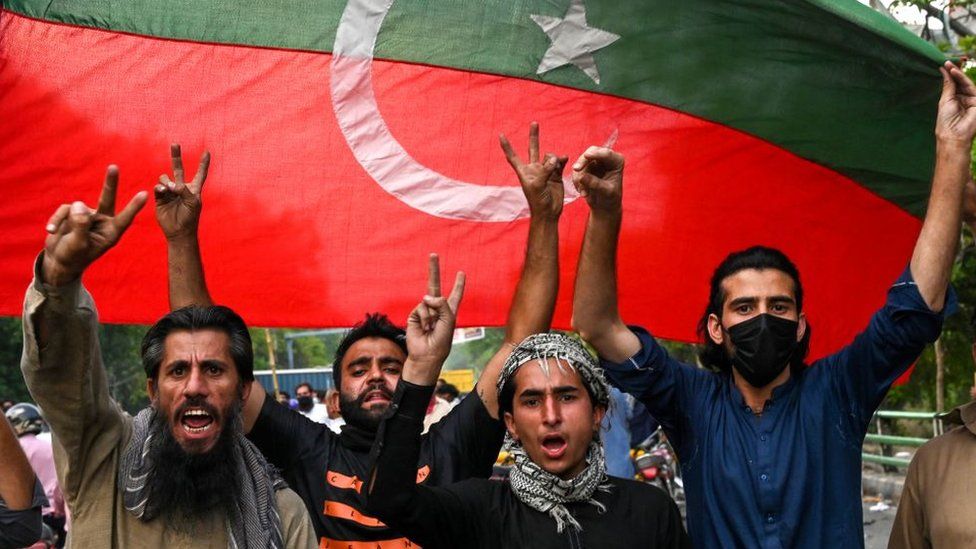 Pakistan Tehreek-e-Insaf (PTI) party activists and supporters of Pakistan's former Prime Minister Imran Khan celebrate after Supreme Court declared Khan's arrest invalid, in Lahore on May 11, 2023.