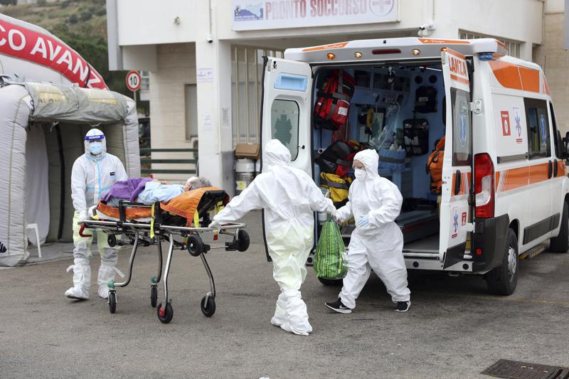 An ambulance for covid emergency unload a patient at the Cervello hospital in Palermo, Sicily, where tented field hospitals have been set up in front of three hospitals to relieve the pressure on the emergency room and allow ambulances to get their patients into a bed rather than wait in line in the parking lot, Friday, Jan. 7, 2022. Sicily has seen its caseload double in recent days, from around 6,000 a day to 14,000 on Thursday, and has just under 1,000 people hospitalized with the virus. (Alberto Lo Bianco/LaPresse via AP)