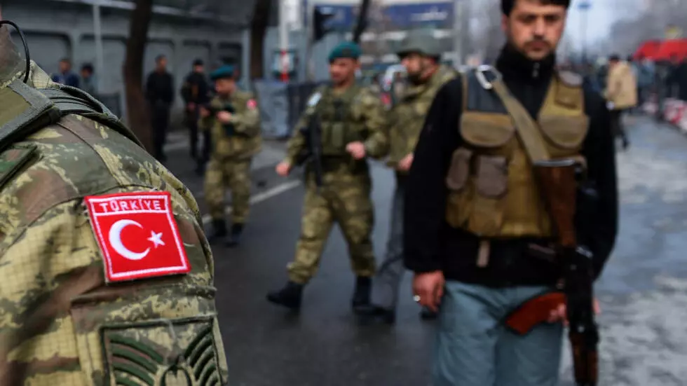 Turkish soldiers and Afghan policemen arrive at the scene following a suicide attack on a Turkish diplomatic vehicle in front of the Iranian embassy in Kabul on February 26, 2015.