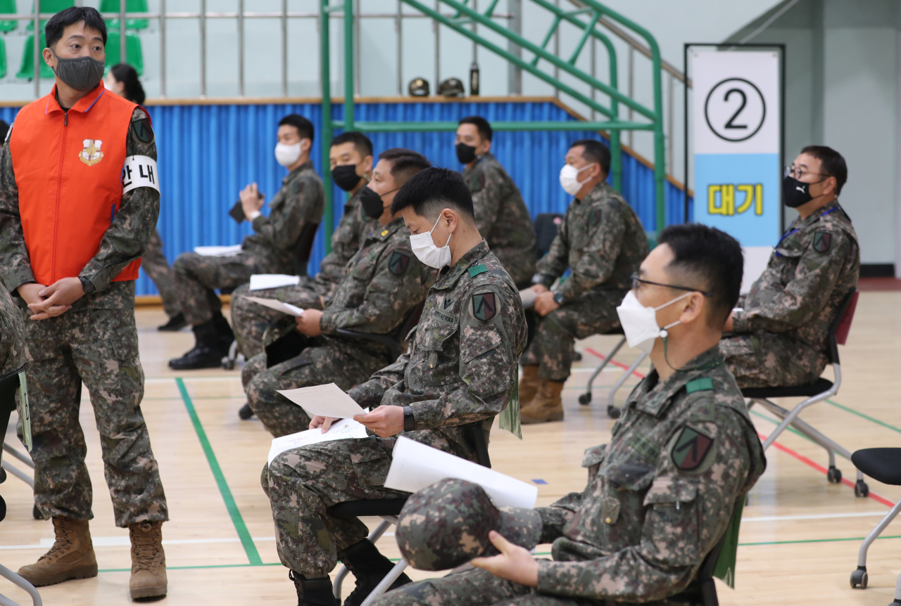 In this file photo, taken on April 28, 2021, and provided by the Kookbang Ilbo newspaper, service members wait to receive coronavirus vaccines at a military hospital in Seongnam, south of Seoul. (Kookbang Ilbo newspaper)