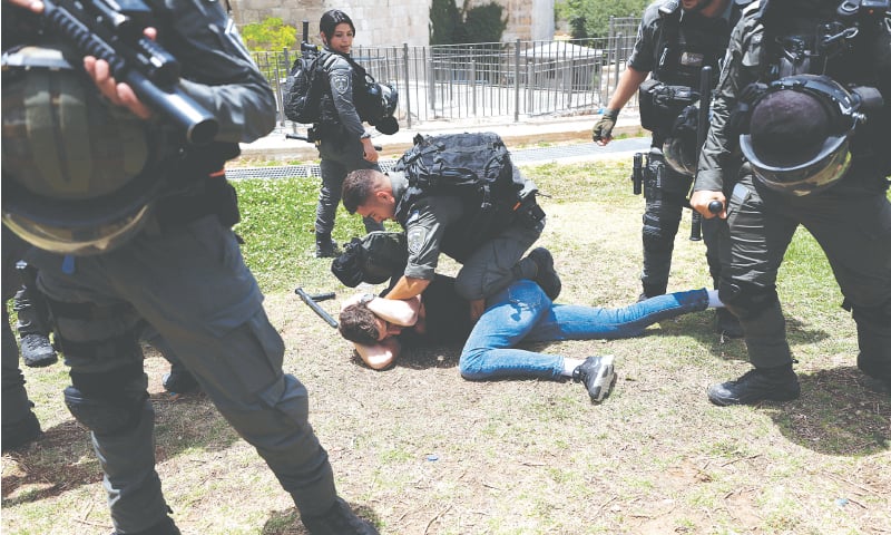 ISRAELI border police detain a Palestinian during clashes near Damascus Gate, in Jerusalem’s Old City, on Sunday.—Reuters