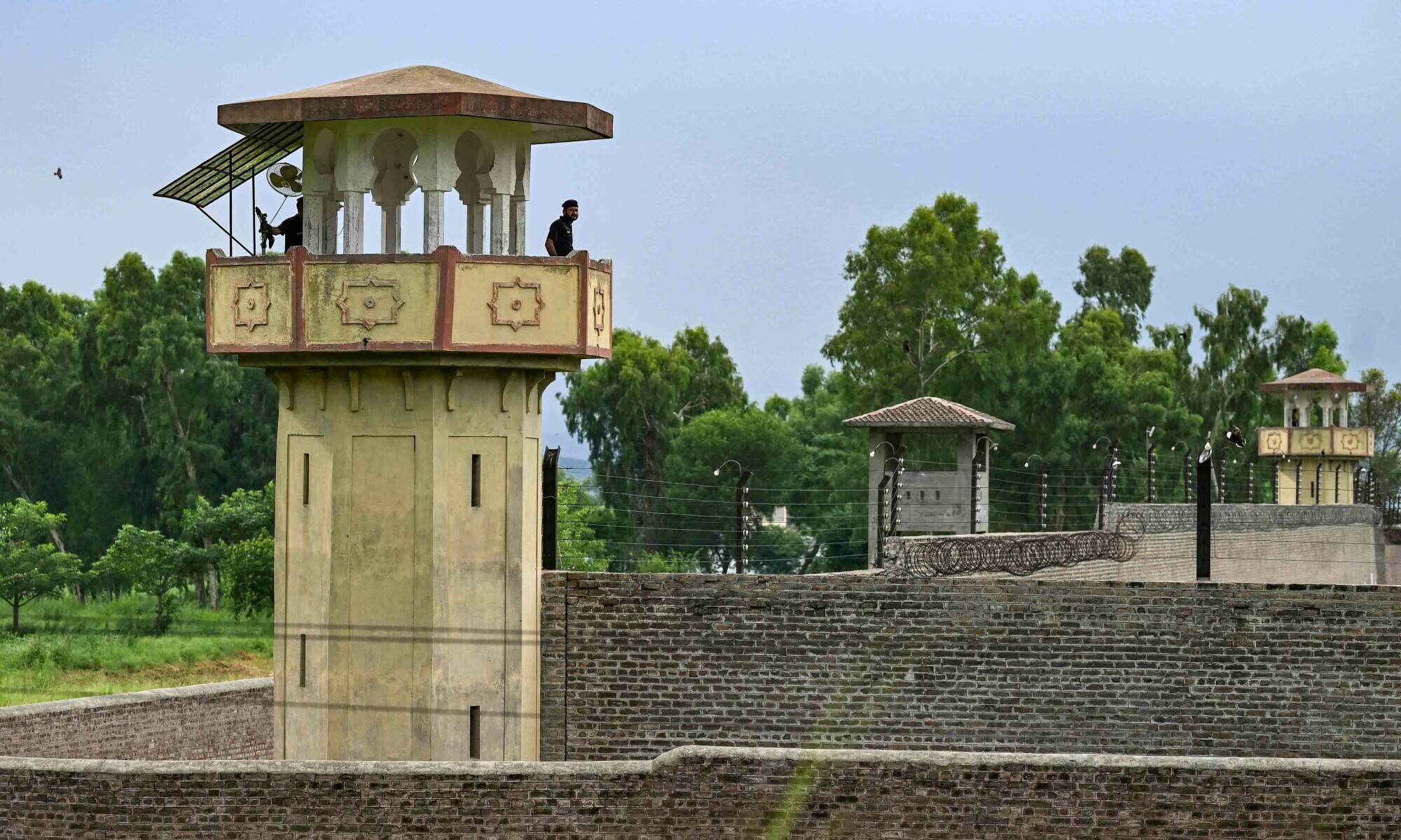 Policemen stand guard at the Attock prison post where PTI chief Imran Khan is being held in Attock on August 6. — AFP