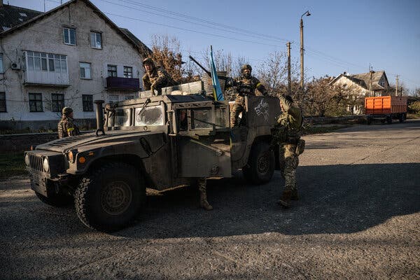 Ukrainian soldiers in the village of Snihurivka, in southern Ukraine, on Thursday, the day after Russia formally announced it had retreated from villages along the Kherson front.