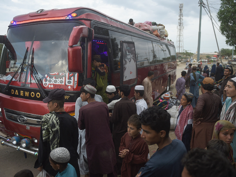 afghans board a bus heading from karachi to afghanistan photo afp