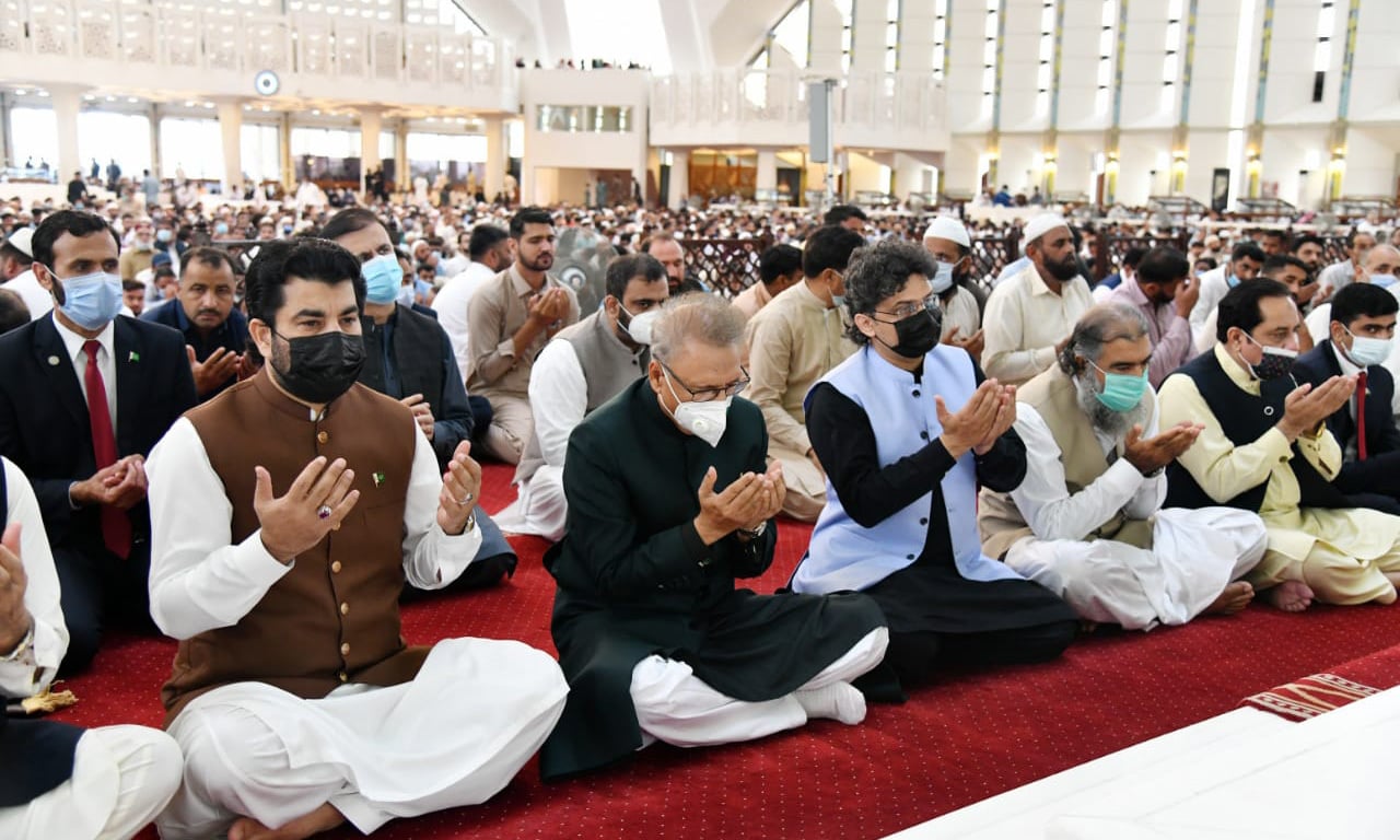 President Dr Arif Alvi (C), National Assembly Deputy Speaker Qasim Khan Suri (L) and Senator Faisal Javed Khan (R) offer Eidul Azha prayers at Faisal Mosque in Islamabad on Wednesday. — Photo courtesy President of Pakistan Twitter.