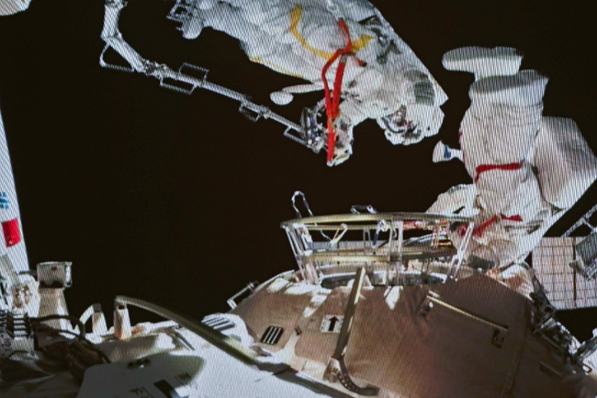 In this image released by the Xinhua News Agency, a photo taken on a screen shows Chinese astronauts Zhai Zhigang and Wang Yaping conducting extravehicular activities outside the space station's Tianhe core module, from the Beijing Aerospace Control Center on Sunday, Nov. 7, 2021. 