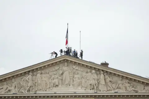 Teresa Suarez/EPA Security forces deploy at the top of the French Parliament during the Opening Ceremony of the Paris 2024 Olympic Games