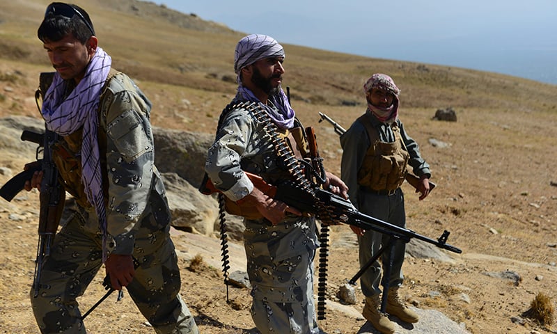 Afghan resistance movement and anti-Taliban uprising forces patrol on a hilltop in Darband area in Anaba district, Panjshir province on September 1. — AFP