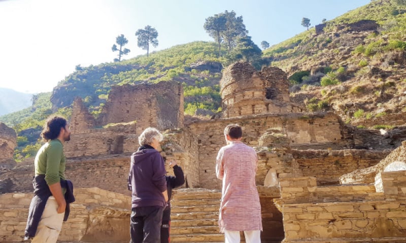 Tourists visit a Buddhist site in Swat. — Dawn
