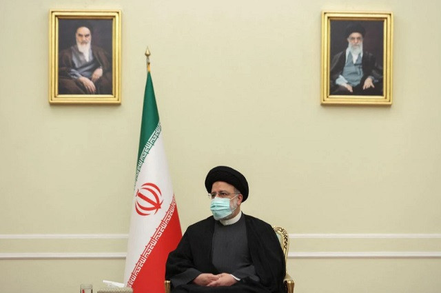 iran s president ebrahim raisi looks on during a meeting with syria s foreign minister faisal mekdad in tehran iran december 6 2021 photo reuters