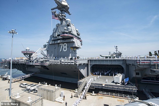 Sailors are seen manning the rails when the USS Ford was commissioned in July 2017. The carrier was expected to be mission ready in 2018, but is still experiencing problems